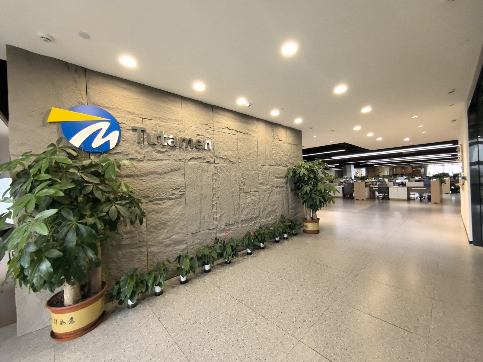 Tutamen Dongguan headquarters — main lobby with company signage and open office floor beyond